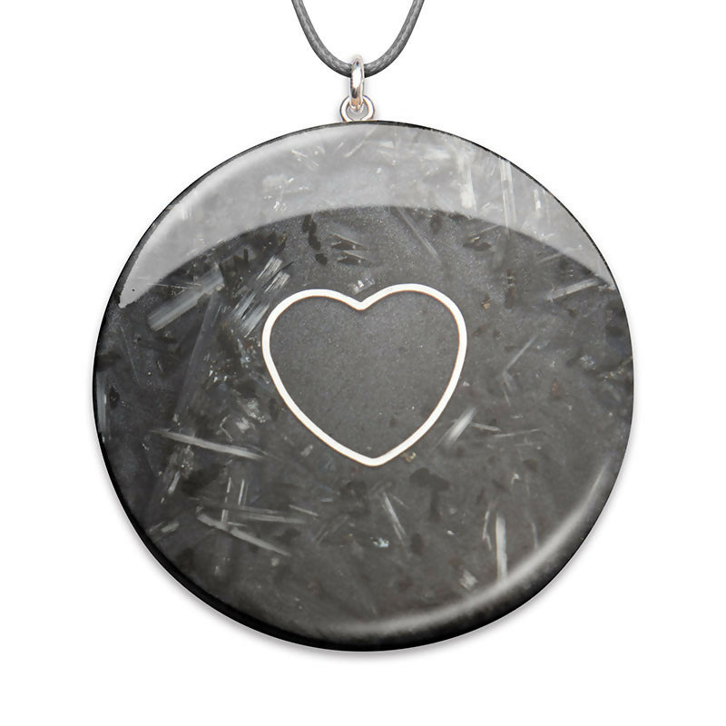 Selenite Silver Heart by Orgonise Africa – round dark grey pendant with a silver heart outline over clear crystal shards, on a grey cord