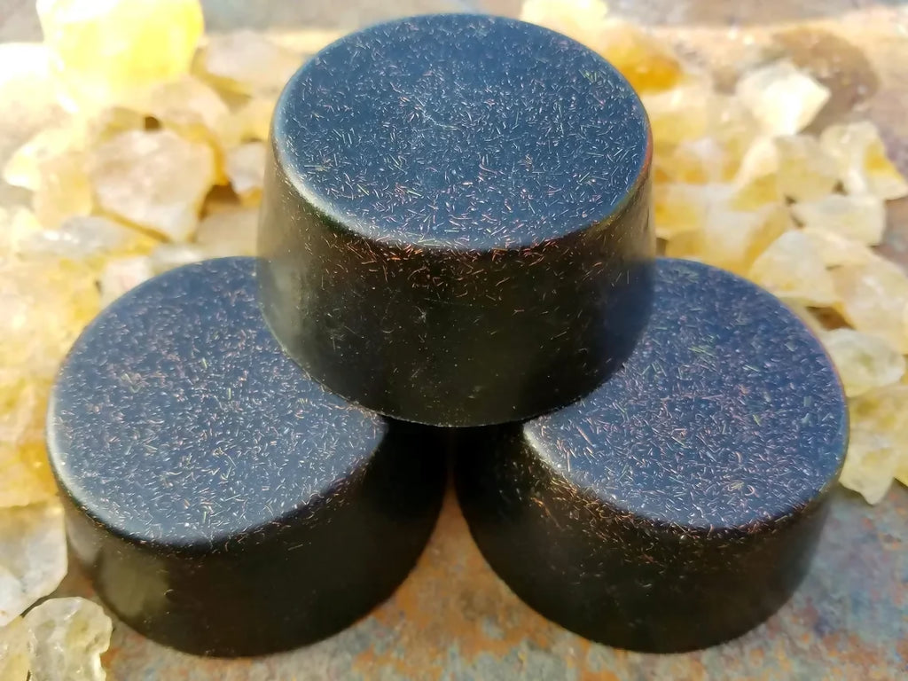Three black tower busters stacked among pale yellow crystals