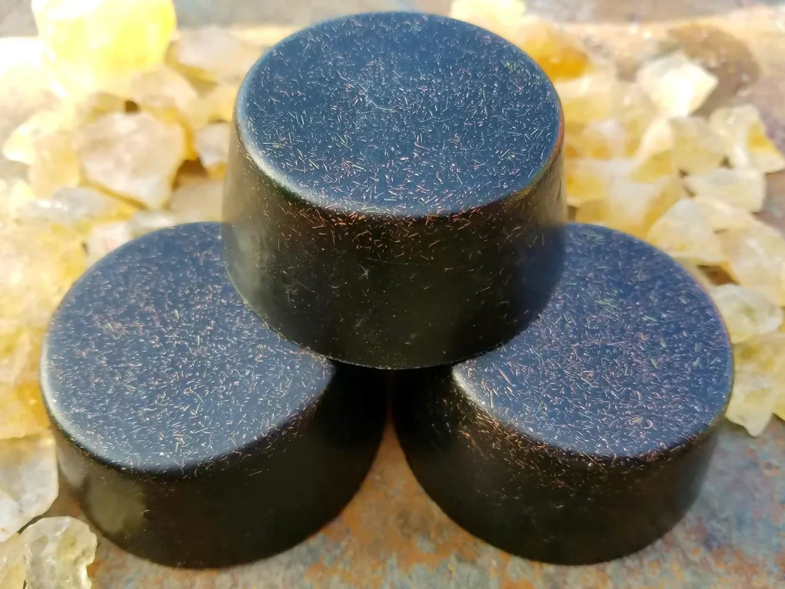 Three black tower busters stacked among pale yellow crystals