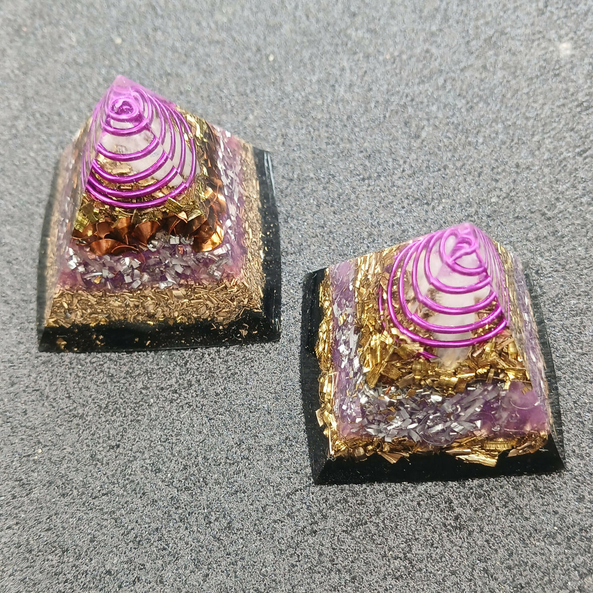 Two mini pyramids with pink wire spirals over gold flakes and lilac stone chips