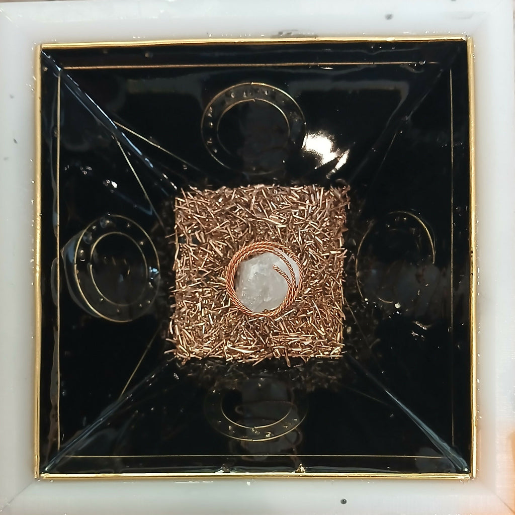Work in progress: inside the mould, a layer of copper shavings with a clear stone and copper coil in the centre