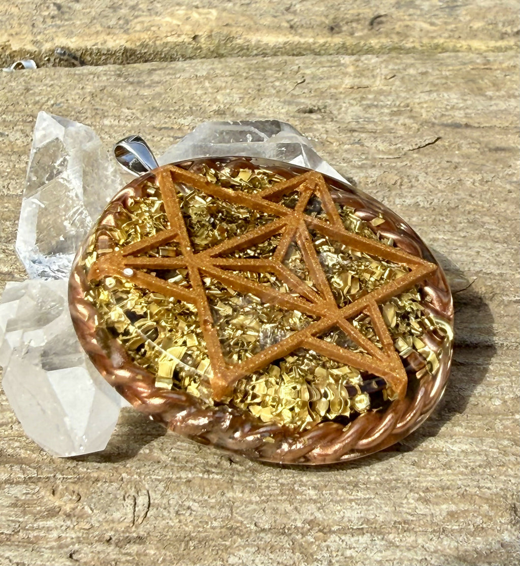 Angled view of the star tetrahedron design on weathered wood, showing gold-coloured flakes in clear resin