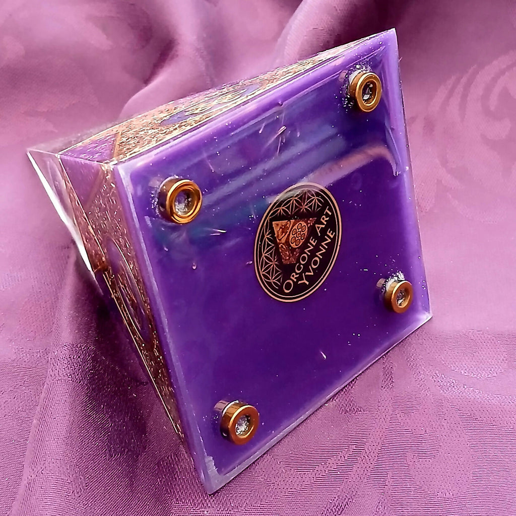 Underside of the pyramid: purple base with four round metal feet and a circular maker's label