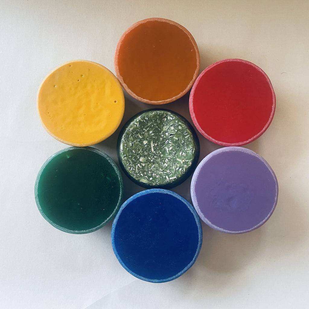 Seven round Slick Jim tower busters arranged as a colour palette, including yellow, orange, red, purple, blue and green