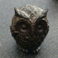 Black owl figure with metal pieces in the resin, front view