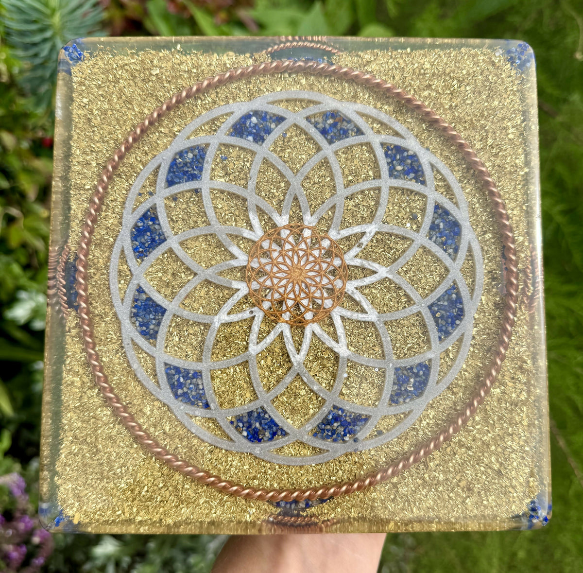 Base of the pyramid: a large silver Torus pattern inlaid with Lapis Lazuli over brass flakes, framed by a twisted copper ring