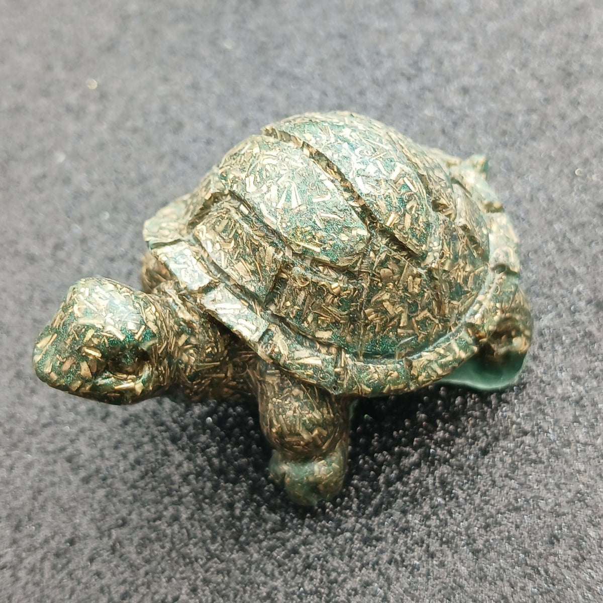 Mini Orgonite Turtles by Orgone Art Yvonne – small dark green turtle figure with metal pieces visible in the shell, side view