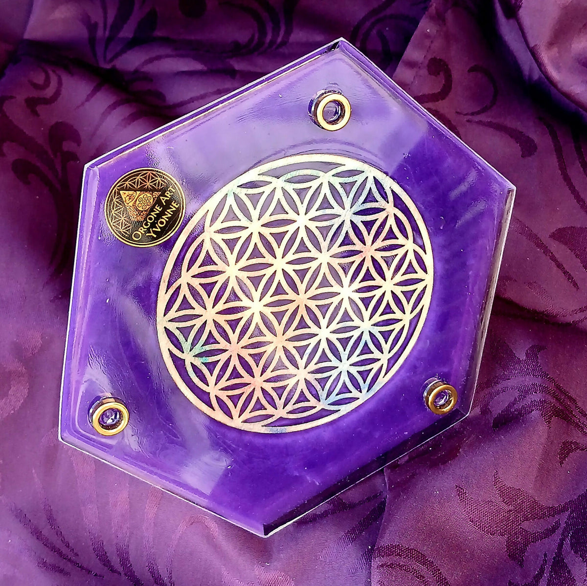 Purple hexagonal underside with Flower of Life decoration, three round feet and Orgone Art Yvonne label.