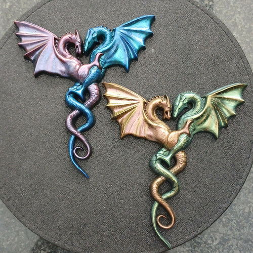 Handmade Orgonite Dragons by Orgone Art Yvonne – two pairs of intertwined winged dragons, one in pink and blue and one in gold and green metallic finishes
