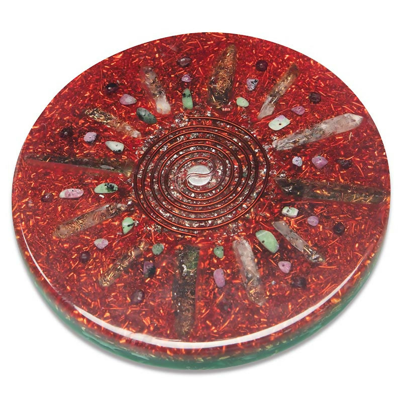Enchanted Garden Orgonite Charging Plate by Orgonise Africa – round red plate with a copper spiral at the centre, clear crystal points and green and purple stone chips arranged like rays