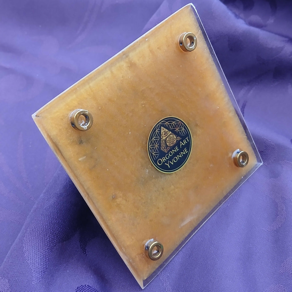 Underside: light tan base with four round metal feet and a dark maker's label