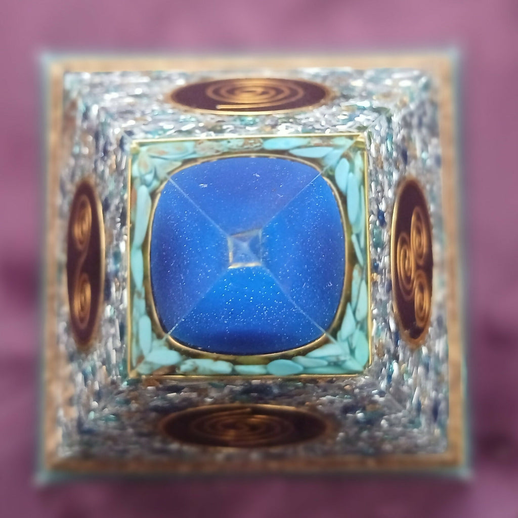 Top-down view of the blue apex sphere with pale blue-green chips and gold spiral discs on each face