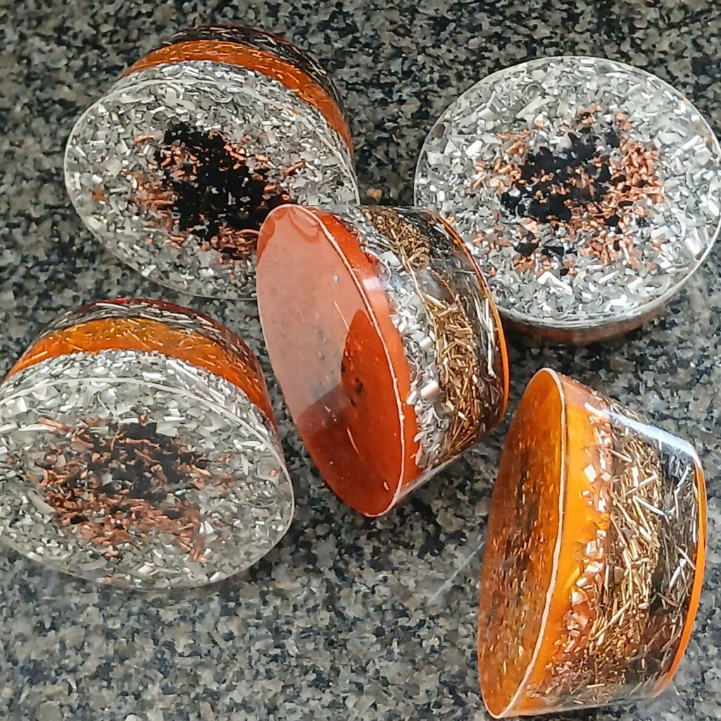 Undersides and side views of dragon towerbusters showing metal shavings within clear resin.