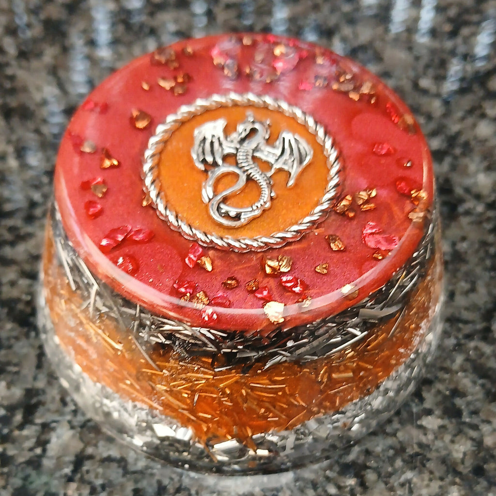 Red dragon towerbuster with a silver-coloured dragon motif on top and layered metal shavings.
