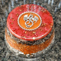 Red dragon towerbuster with a silver-coloured dragon motif on top and layered metal shavings.