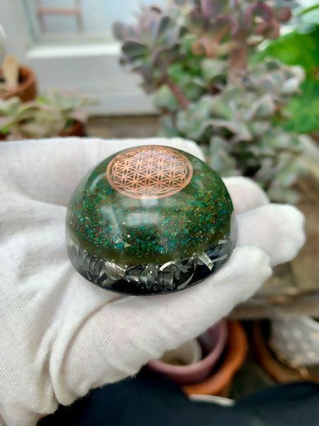 Etched Copper Flower of Life Tower Buster by Mark Ethan Designs – green domed tower buster with an etched copper Flower of Life disc on top and silver shavings at the base, held in a gloved hand