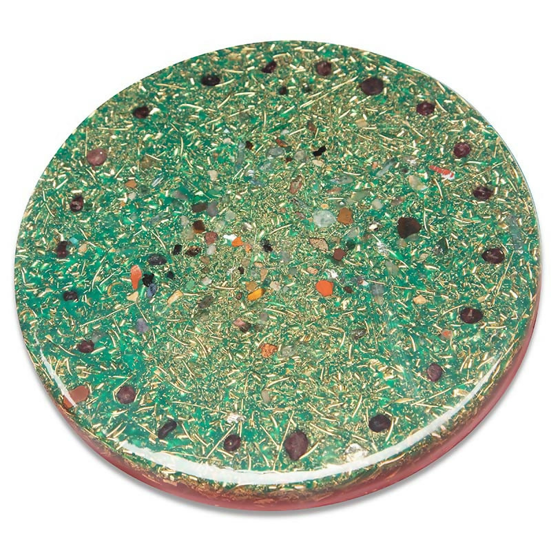 Back of the plate covered in green metal shavings with small red and brown stone chips
