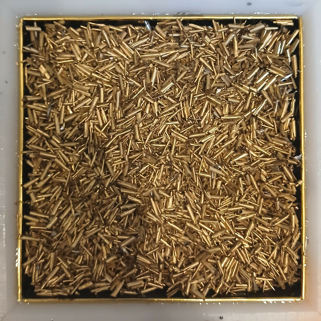 Work in progress: a final layer of brass-coloured metal pieces covering the mould