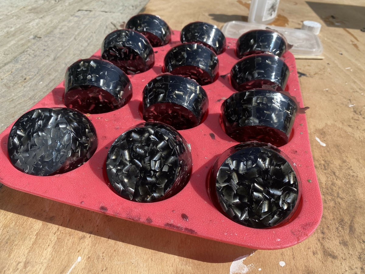 Black shungite orgonite towerbusters in a red mould