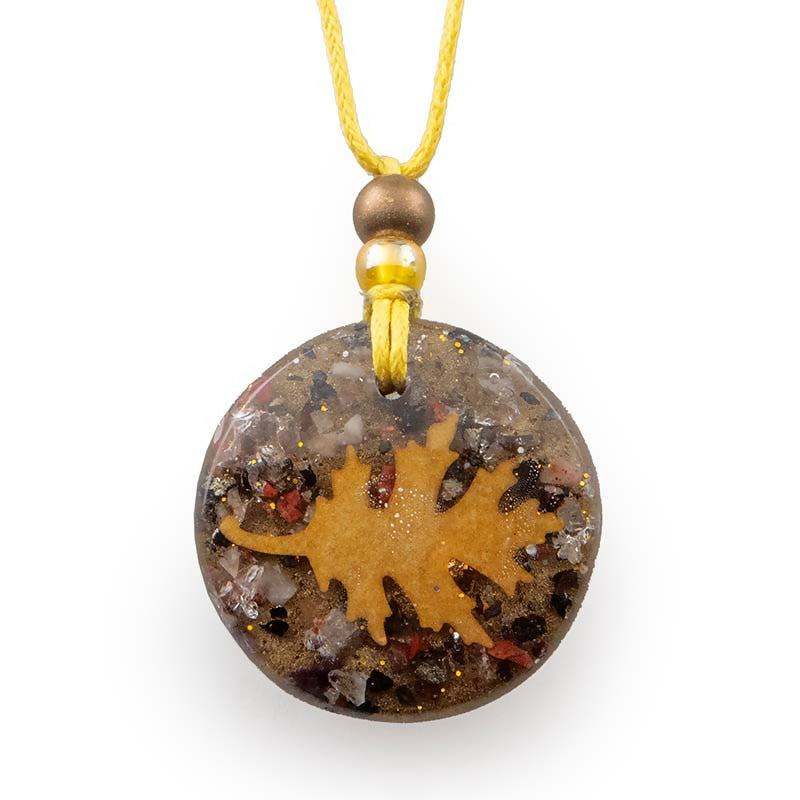 Small round pendant with a gold leaf shape over brown and grey chips, on a yellow cord with beads