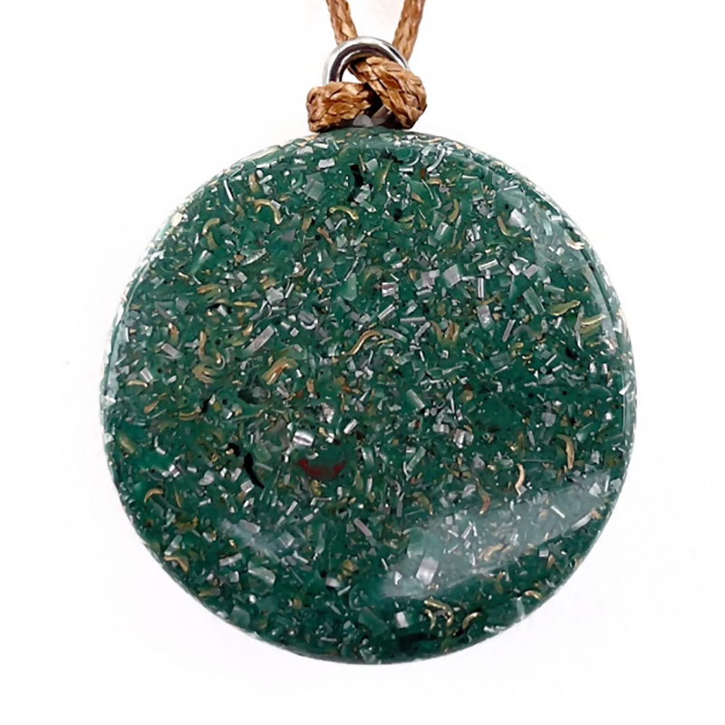 Back of the round pendant showing a dark green surface with metal flecks