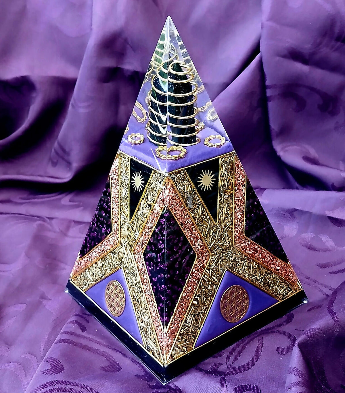Purple Nubian Pyramid by Orgone Art Yvonne – tall purple pyramid with a gold-ringed dark cone in the clear tip, gold and copper flake star shapes and purple-black panels