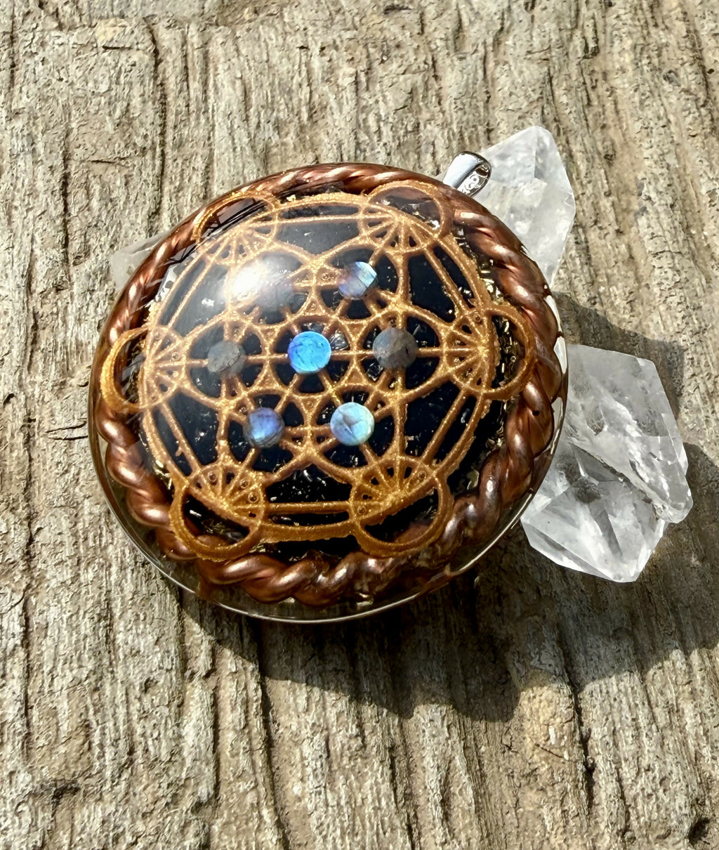 Angled view of the Metatron’s Cube face catching sunlight, with blue stones and clear quartz points behind