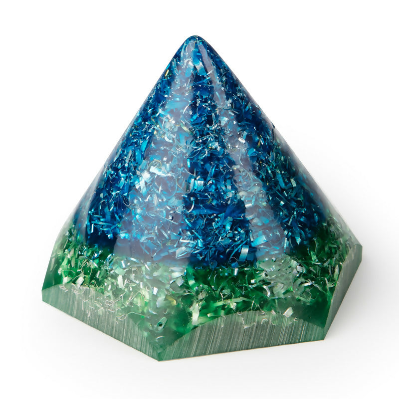 Blue cone-shaped piece with blue and silver shavings over a green hexagonal base, side view