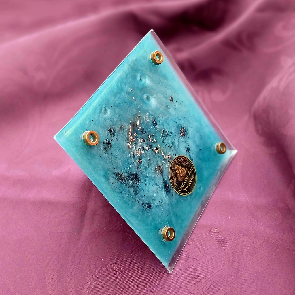 Underside: turquoise base with dark flecks, round metal feet and a maker's emblem