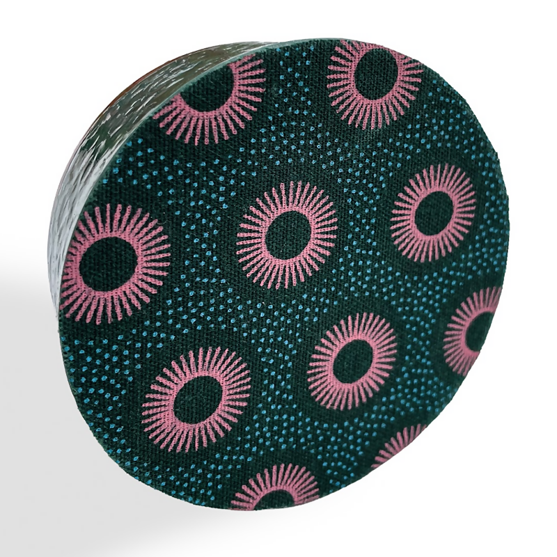 Underside covered in dark green fabric with a pink sunburst circle pattern